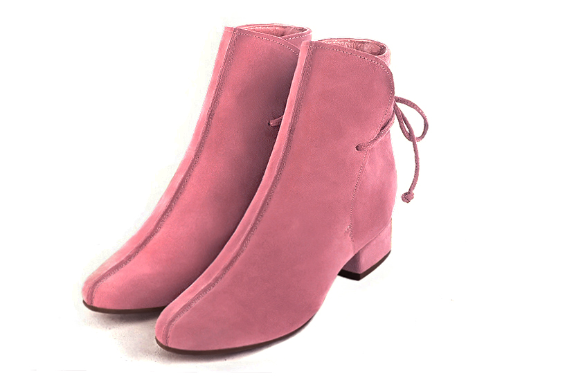 Feminine back lace-up ankle boots featuring romantic corset-style ties, designed for a striking silhouette from day to evening, in blush pink leather with round toe and low block heel